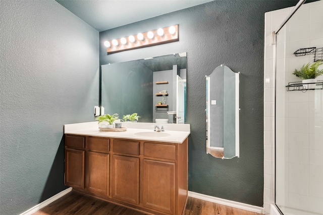 bathroom with vanity, hardwood / wood-style floors, and walk in shower