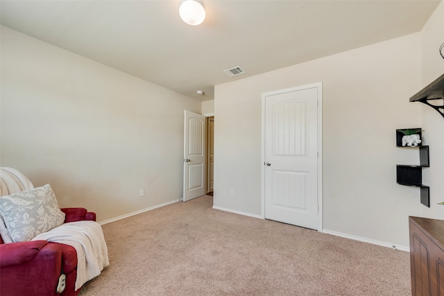 sitting room featuring light carpet