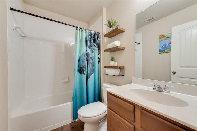 full bathroom with vanity, hardwood / wood-style floors, shower / bath combo, and toilet