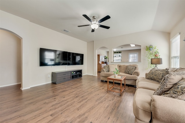 living room with ceiling fan, vaulted ceiling, plenty of natural light, and hardwood / wood-style floors