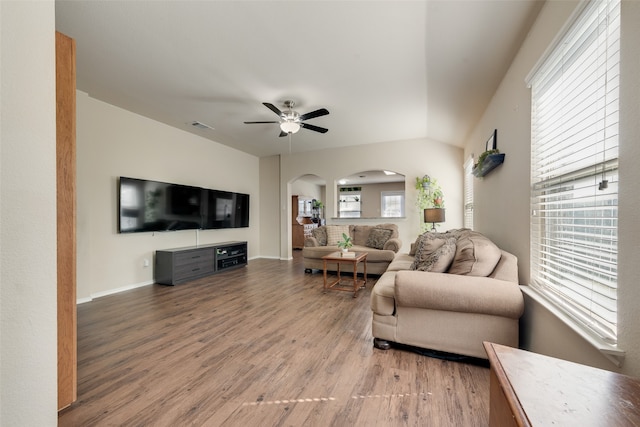 living room featuring a healthy amount of sunlight, ceiling fan, and hardwood / wood-style flooring