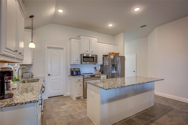 4035 Three Forks Rd, Kaufman, TX 75142 - kitchen with appliances with stainless steel finishes, a sink, decorative backsplash, white cabinetry, and light stone counters