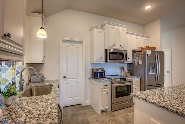 kitchen featuring light stone counters, sink, white cabinets, and stainless steel appliances