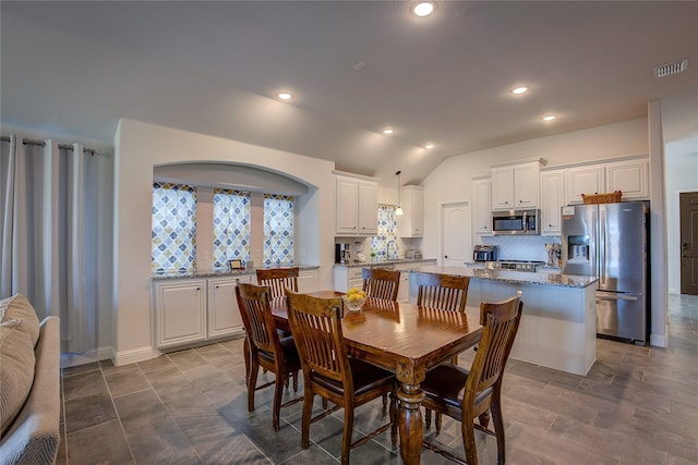 dining area featuring lofted ceiling