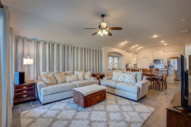 living room with ceiling fan and vaulted ceiling