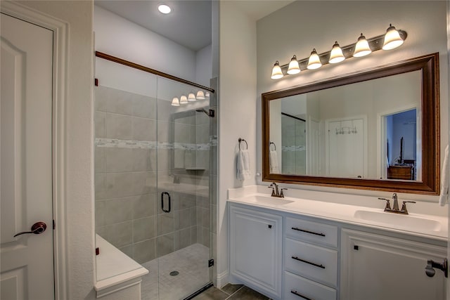 bathroom featuring vanity, tile patterned floors, and walk in shower