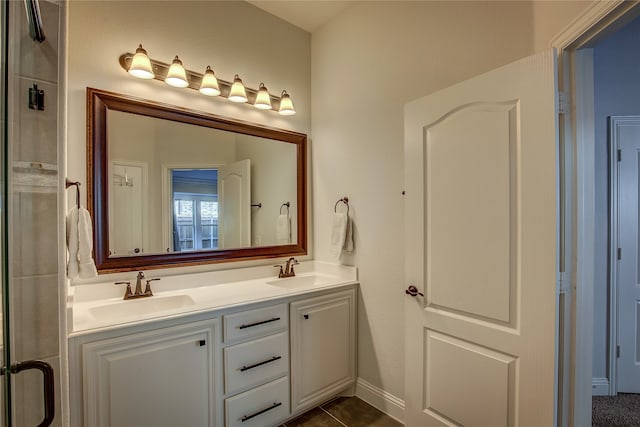 bathroom featuring tile patterned flooring, vanity, and walk in shower