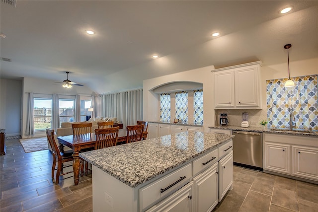 4035 Three Forks Rd, Kaufman, TX 75142 - kitchen with stainless steel dishwasher, a sink, ceiling fan, decorative backsplash, and a kitchen island