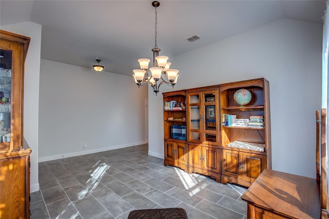 interior space featuring lofted ceiling and an inviting chandelier