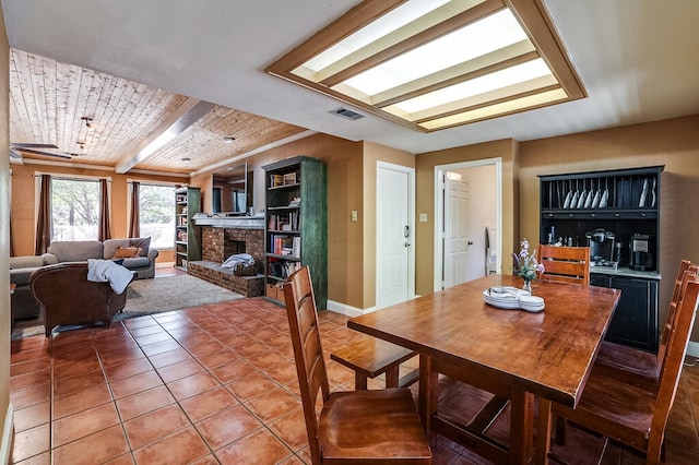 tiled dining area featuring a fireplace