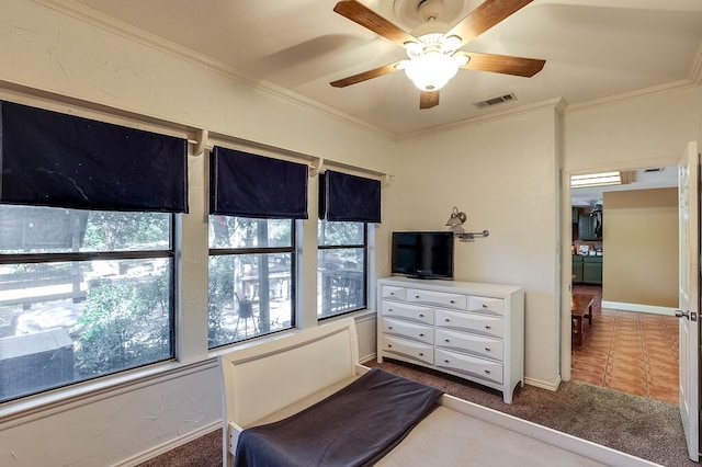 carpeted bedroom with ceiling fan and crown molding