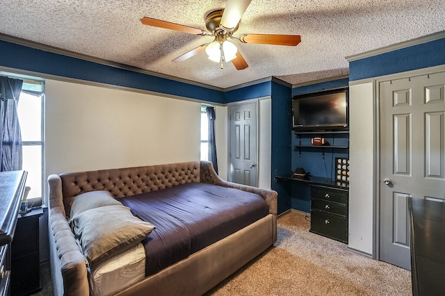 carpeted bedroom featuring crown molding, a textured ceiling, two closets, and ceiling fan