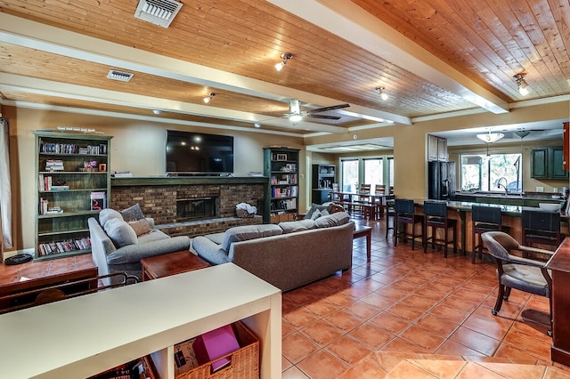 tiled living room featuring beam ceiling, sink, ceiling fan, and wooden ceiling