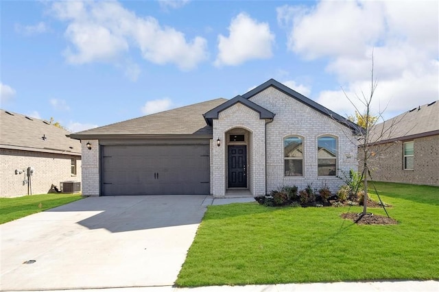 french country home with a front yard and a garage