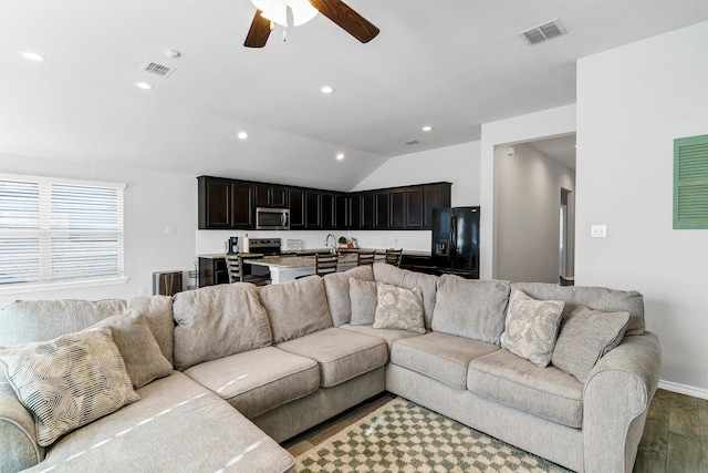 living room with ceiling fan, wood-type flooring, sink, and lofted ceiling