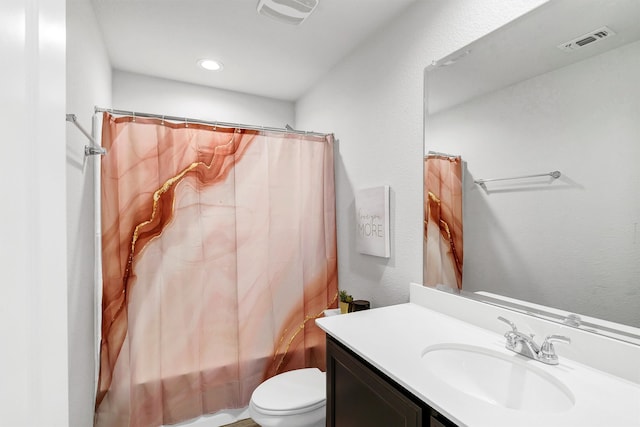 full bathroom featuring vanity, shower / bath combo with shower curtain, and toilet