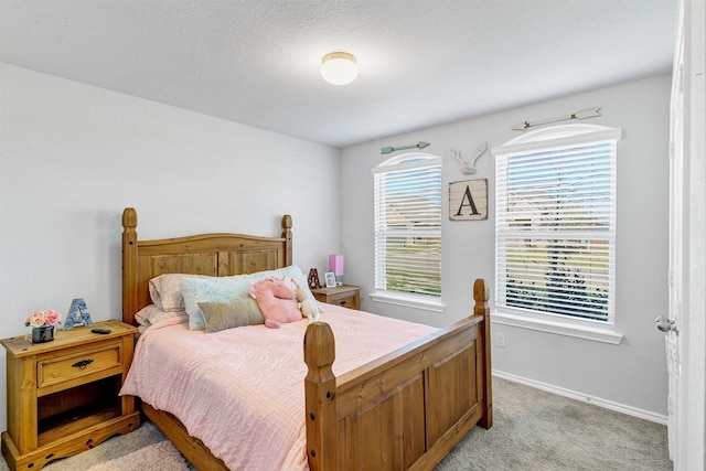 carpeted bedroom with a textured ceiling