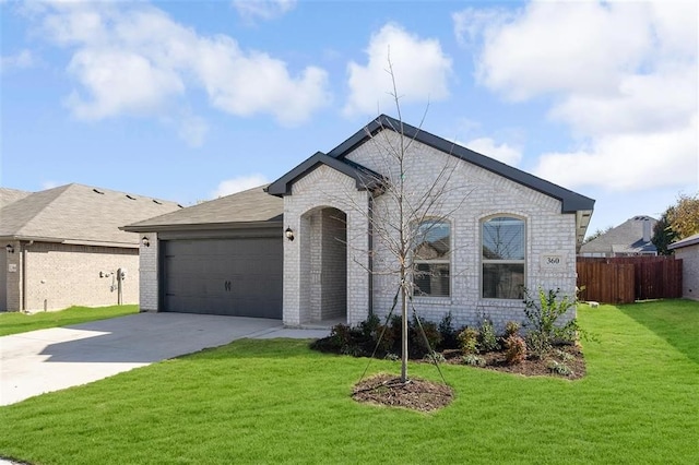 view of front of home with a garage and a front lawn