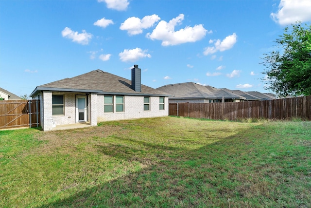 back of house with a lawn