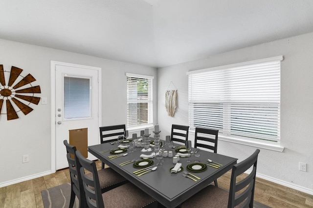 dining space with dark hardwood / wood-style flooring