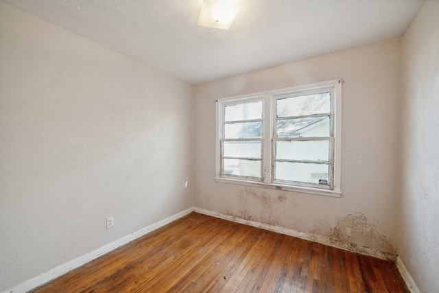 unfurnished room with hardwood / wood-style floors