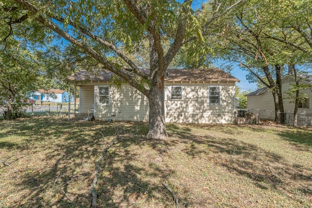 rear view of property featuring a lawn