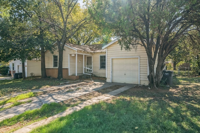 ranch-style home featuring a front lawn and a garage