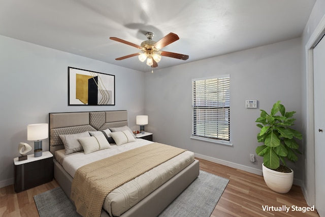 bedroom featuring a closet, ceiling fan, and light hardwood / wood-style flooring