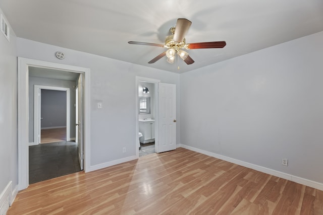 unfurnished bedroom with light hardwood / wood-style flooring, ensuite bathroom, and ceiling fan