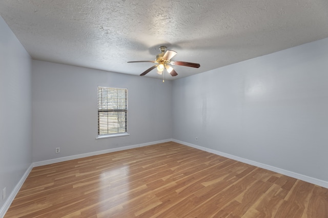 empty room featuring light hardwood / wood-style flooring, a textured ceiling, and ceiling fan