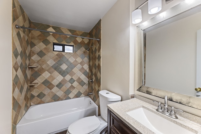 full bathroom with vanity, tiled shower / bath combo, and toilet