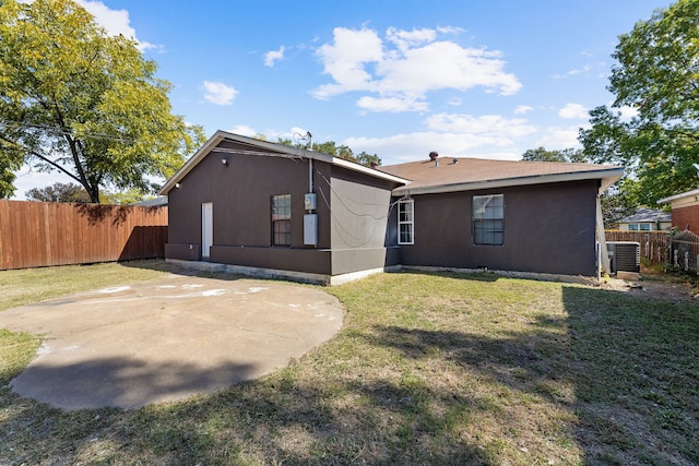 back of house featuring a patio and a yard