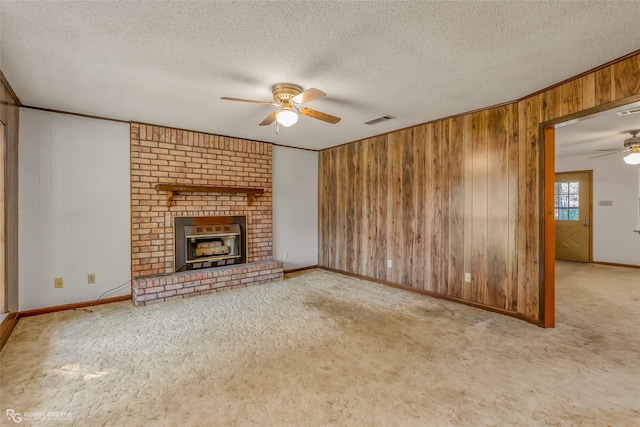 unfurnished living room with ceiling fan, a textured ceiling, and light colored carpet