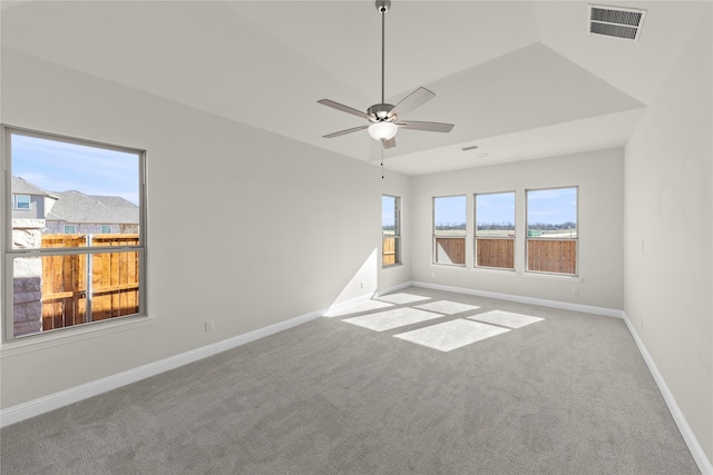 empty room with ceiling fan and light carpet