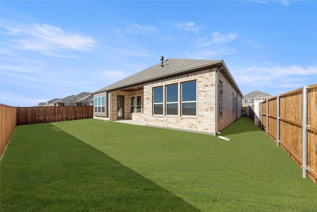 rear view of property with a lawn