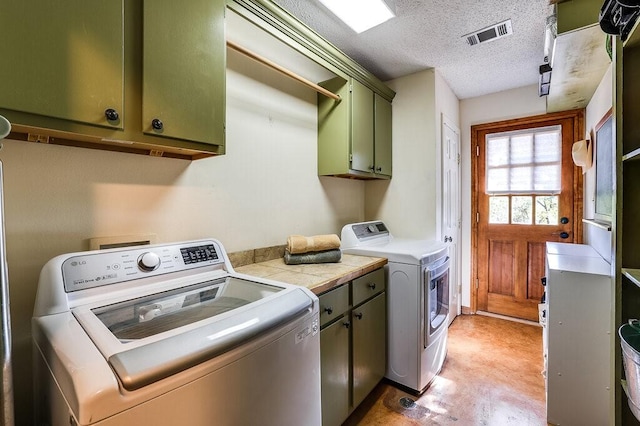 6048 Casey Ct, Fort Worth, TX 76140 - clothes washing area with cabinet space, a textured ceiling, visible vents, and washer and clothes dryer