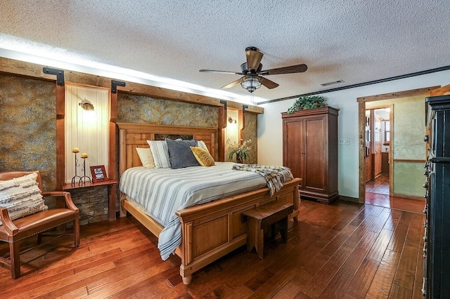 6048 Casey Ct, Fort Worth, TX 76140 - bedroom featuring dark wood-type flooring, a textured ceiling, ceiling fan, and visible vents