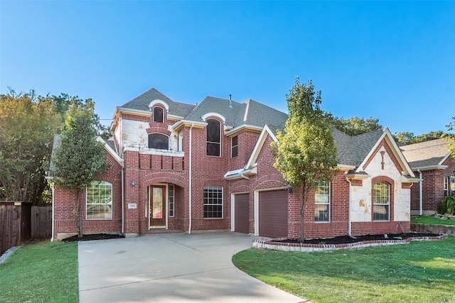 view of front facade with a garage and a front lawn