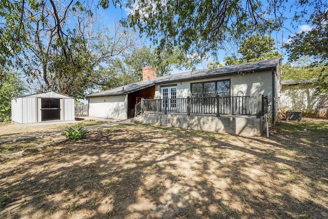 ranch-style home featuring a storage shed