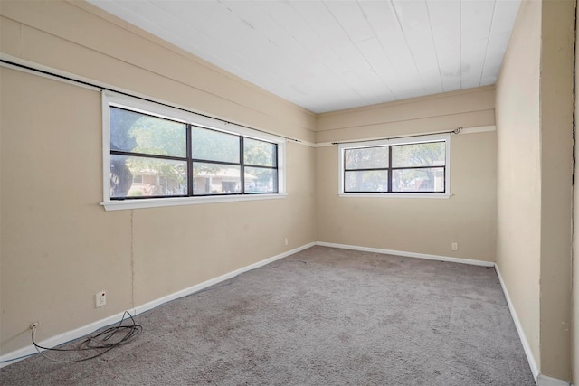 unfurnished room featuring light carpet