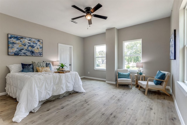 bedroom with ceiling fan and light hardwood / wood-style floors