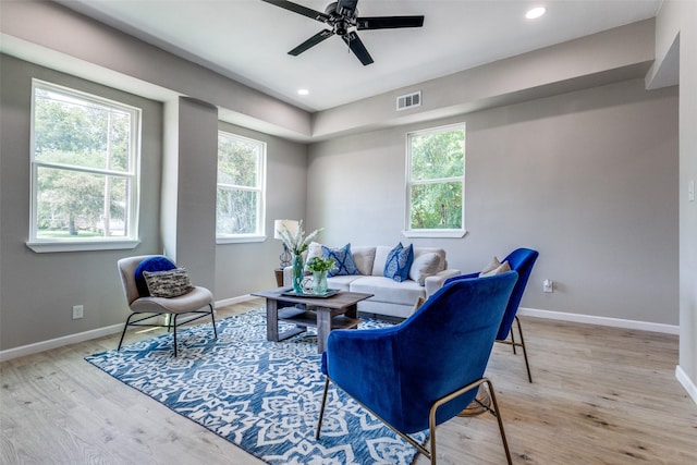 living room featuring ceiling fan and light hardwood / wood-style floors