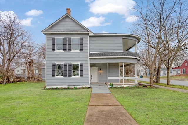 view of front of property with covered porch and a front yard