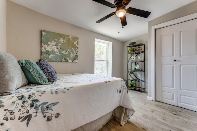 bedroom featuring light hardwood / wood-style floors, a closet, and ceiling fan