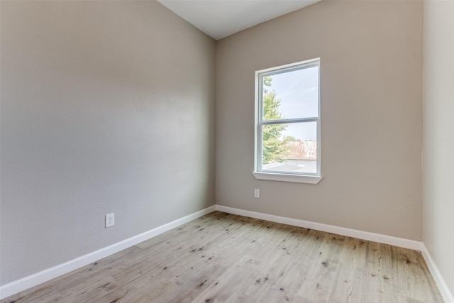 spare room with light hardwood / wood-style flooring