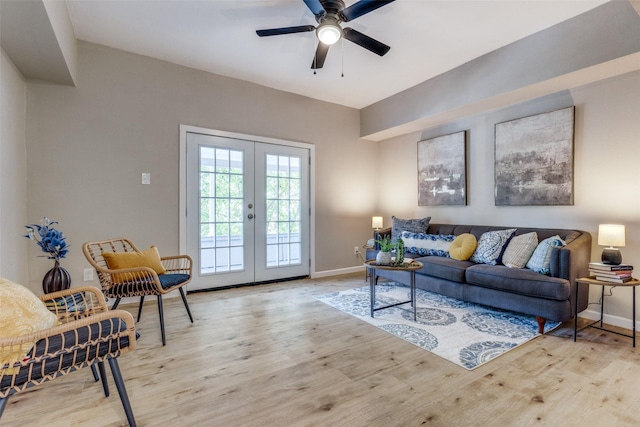 living room with ceiling fan, light hardwood / wood-style flooring, and french doors