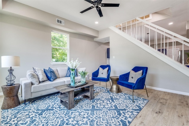 living room with hardwood / wood-style flooring and ceiling fan