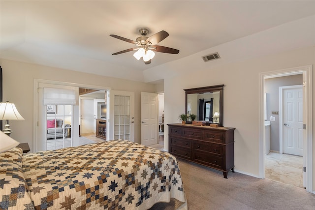 bedroom with light carpet, connected bathroom, and ceiling fan