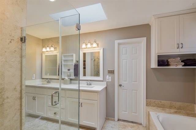 bathroom with separate shower and tub, a skylight, and vanity