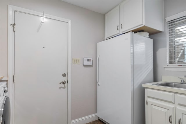 clothes washing area with washer / clothes dryer and sink